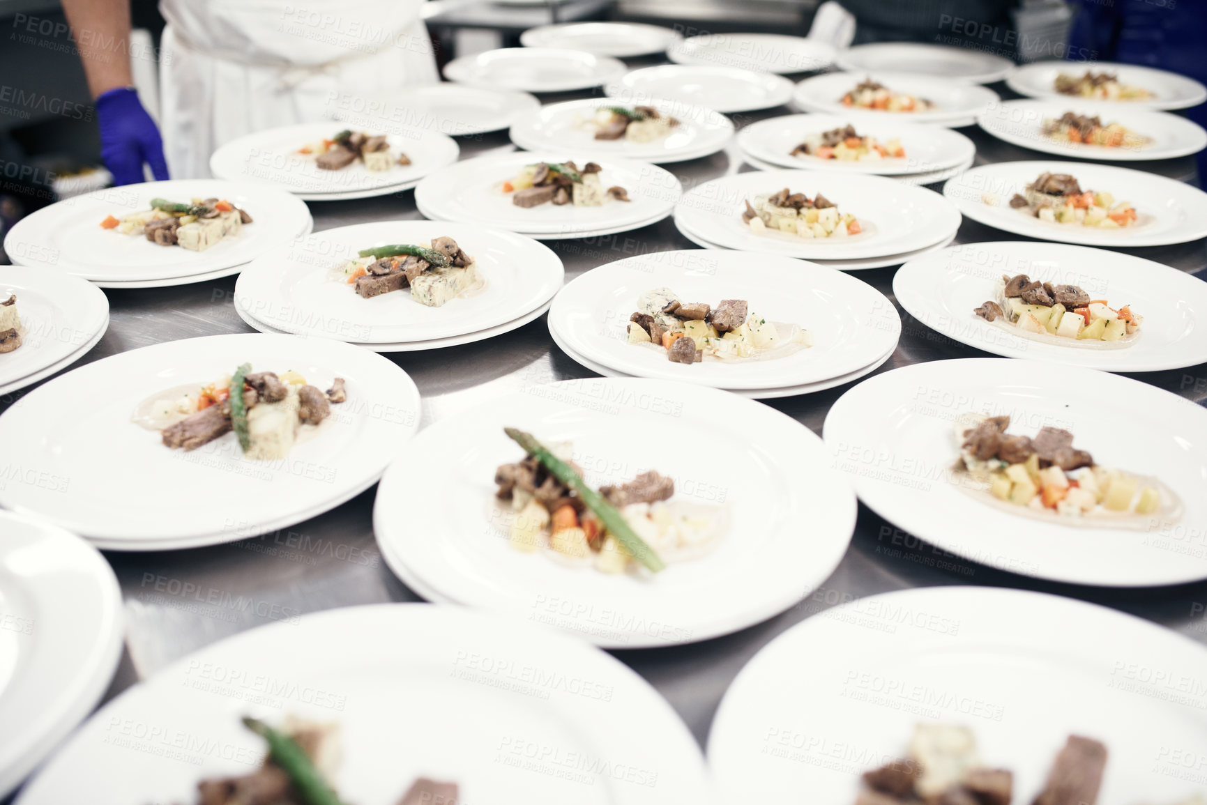 Buy stock photo Shot of plates being prepared for a meal service in a professional kitchen