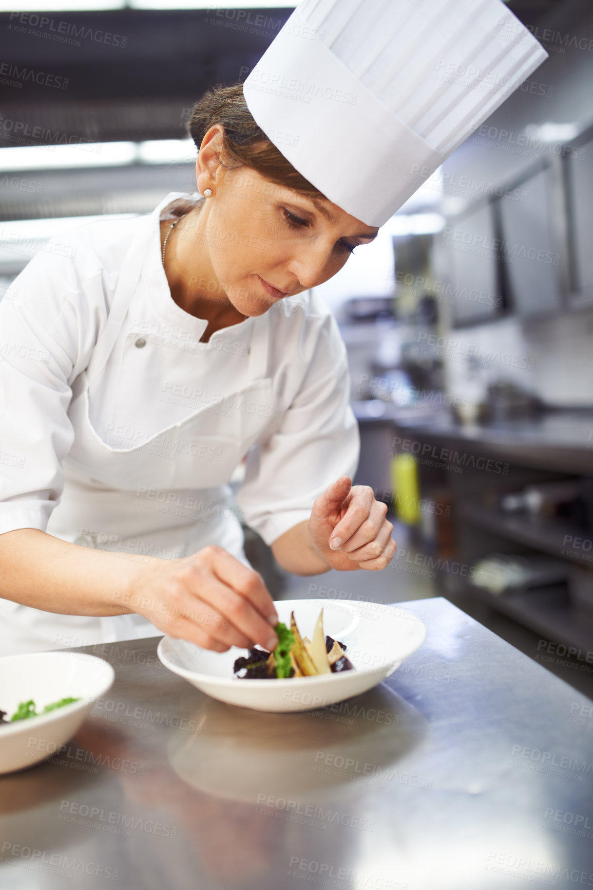 Buy stock photo Chef, plate and hands of woman in kitchen for catering service, fine dining or prepare dish. Hospitality, presentation and female person for cooking meal, food industry or dinner in restaurant