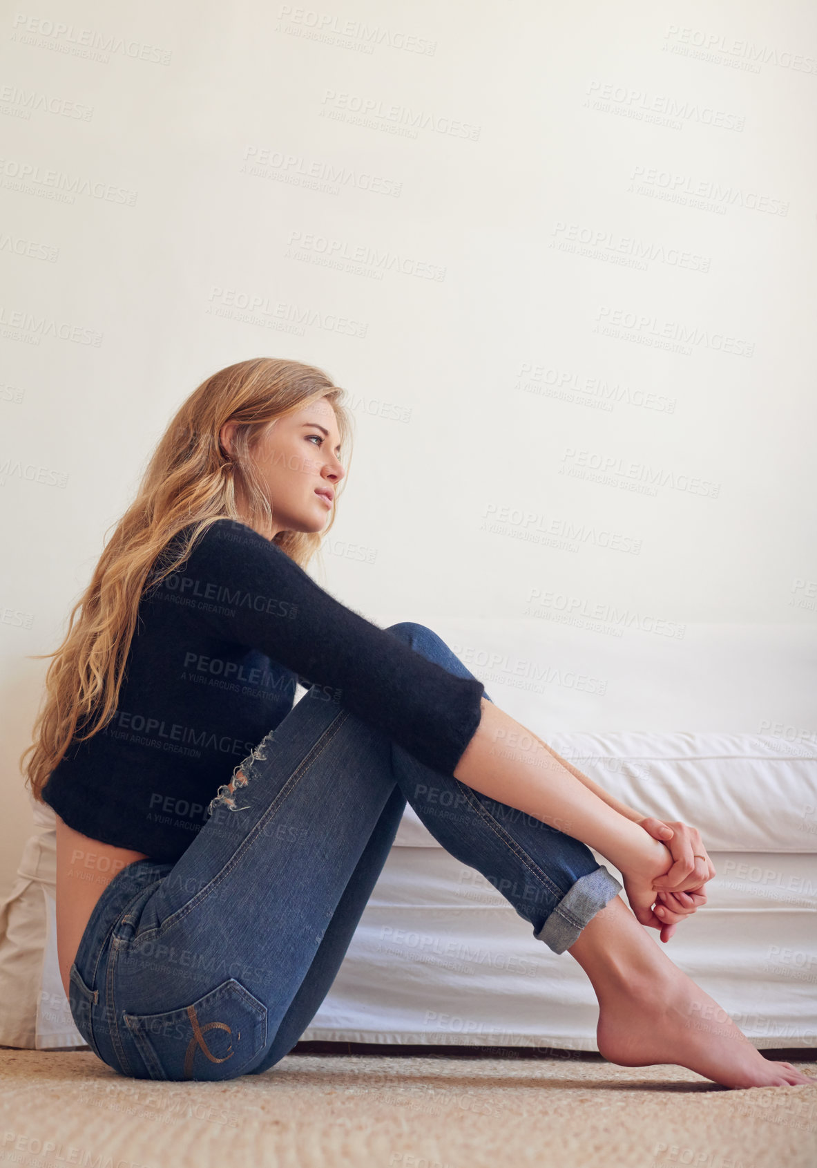 Buy stock photo Shot of a beautiful young woman sitting on her bedroom floor