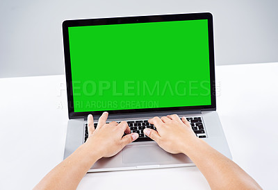 Buy stock photo Shot of a person using a laptop with a green screen