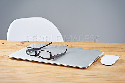 Buy stock photo Table, laptop and glasses in office, setup and equipment for work, empty and organized for business. Desk, tech and eyewear in workplace, chair and wireless for corporate, career and job in company