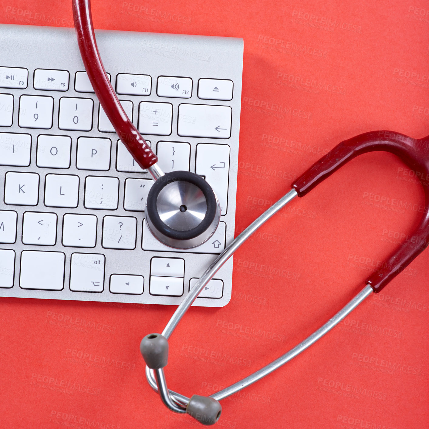 Buy stock photo Keyboard, stethoscope and diagnostic in studio for service, IT support or computer virus prevention. Above, PC keypad or medical tool on red background for troubleshoot, tech help and problem solving