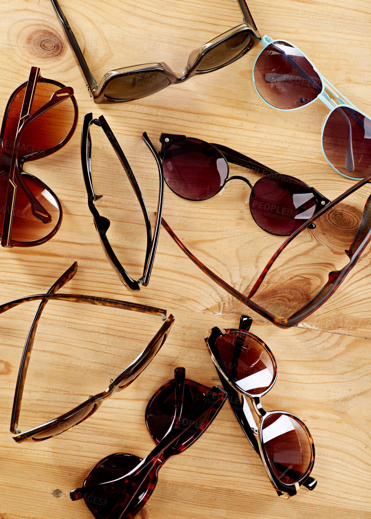Buy stock photo Shot of a collection of sunglasses on a table top