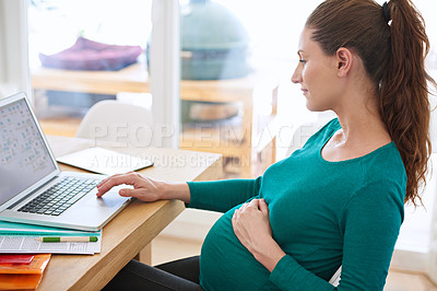 Buy stock photo Shot of a pregnant woman using her laptop at home