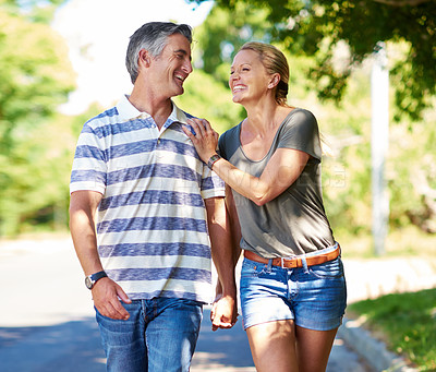 Buy stock photo Cropped shot of an affectionate mature couple enjoying a day in the park