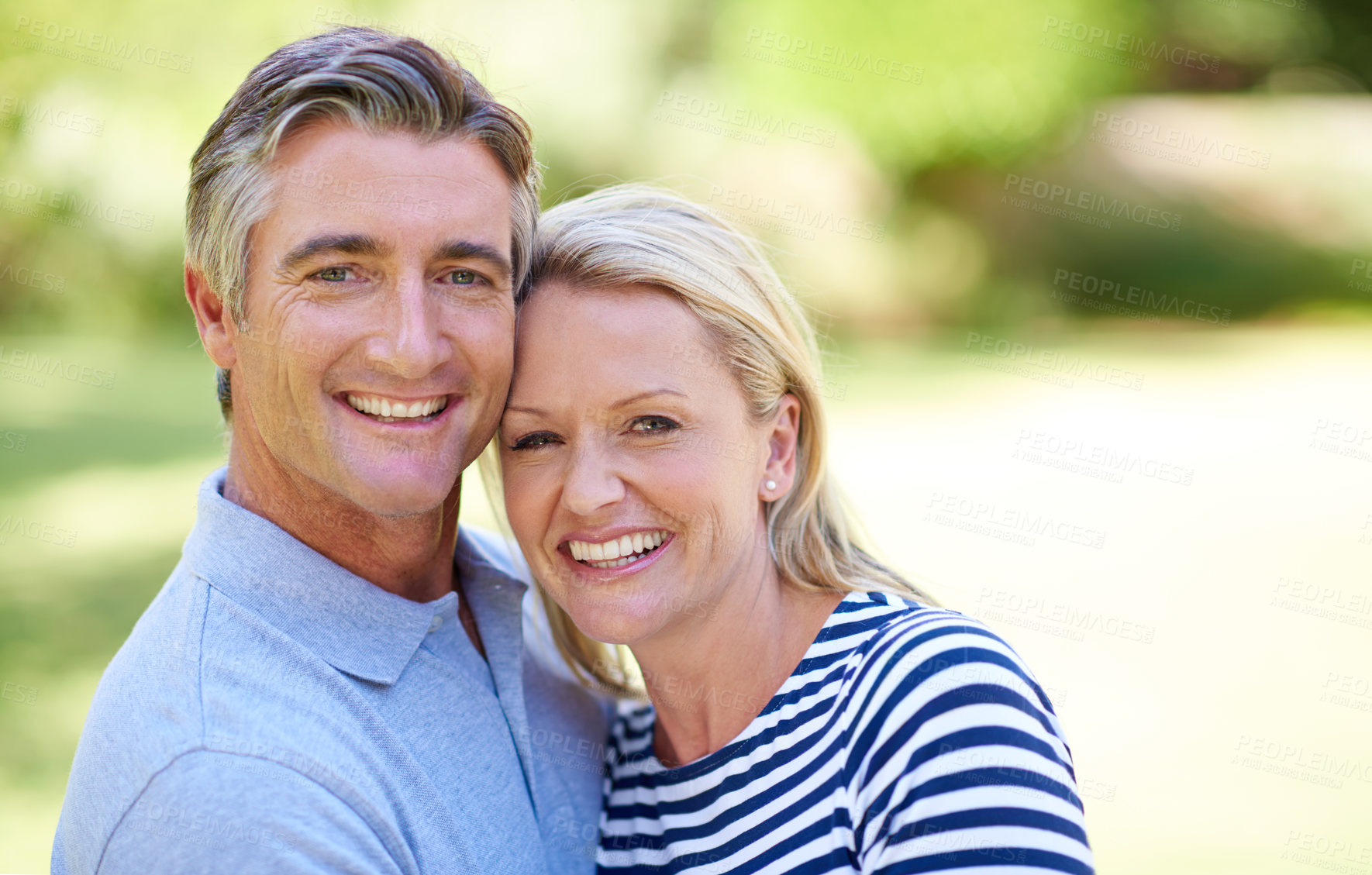 Buy stock photo Cropped shot of an affectionate mature couple enjoying a day in the park