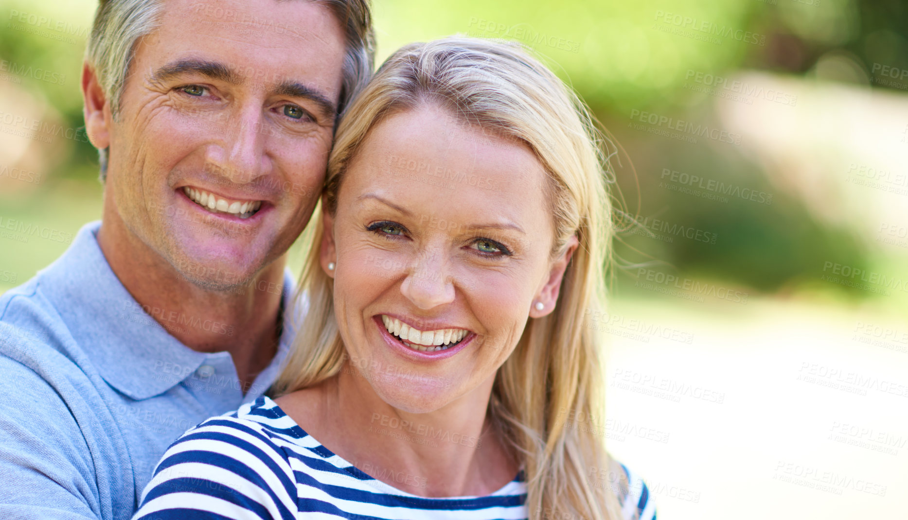 Buy stock photo Cropped shot of an affectionate mature couple enjoying a day in the park