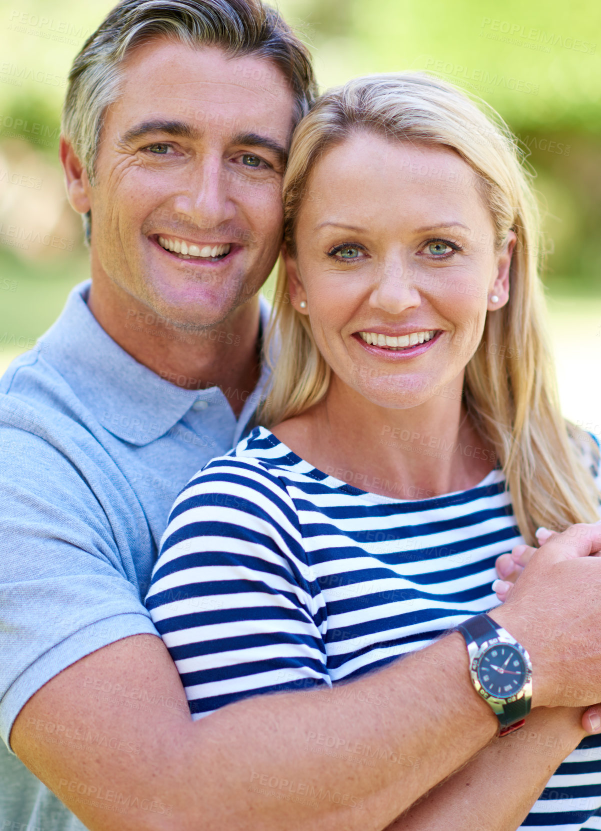 Buy stock photo Cropped shot of an affectionate mature couple enjoying a day in the park