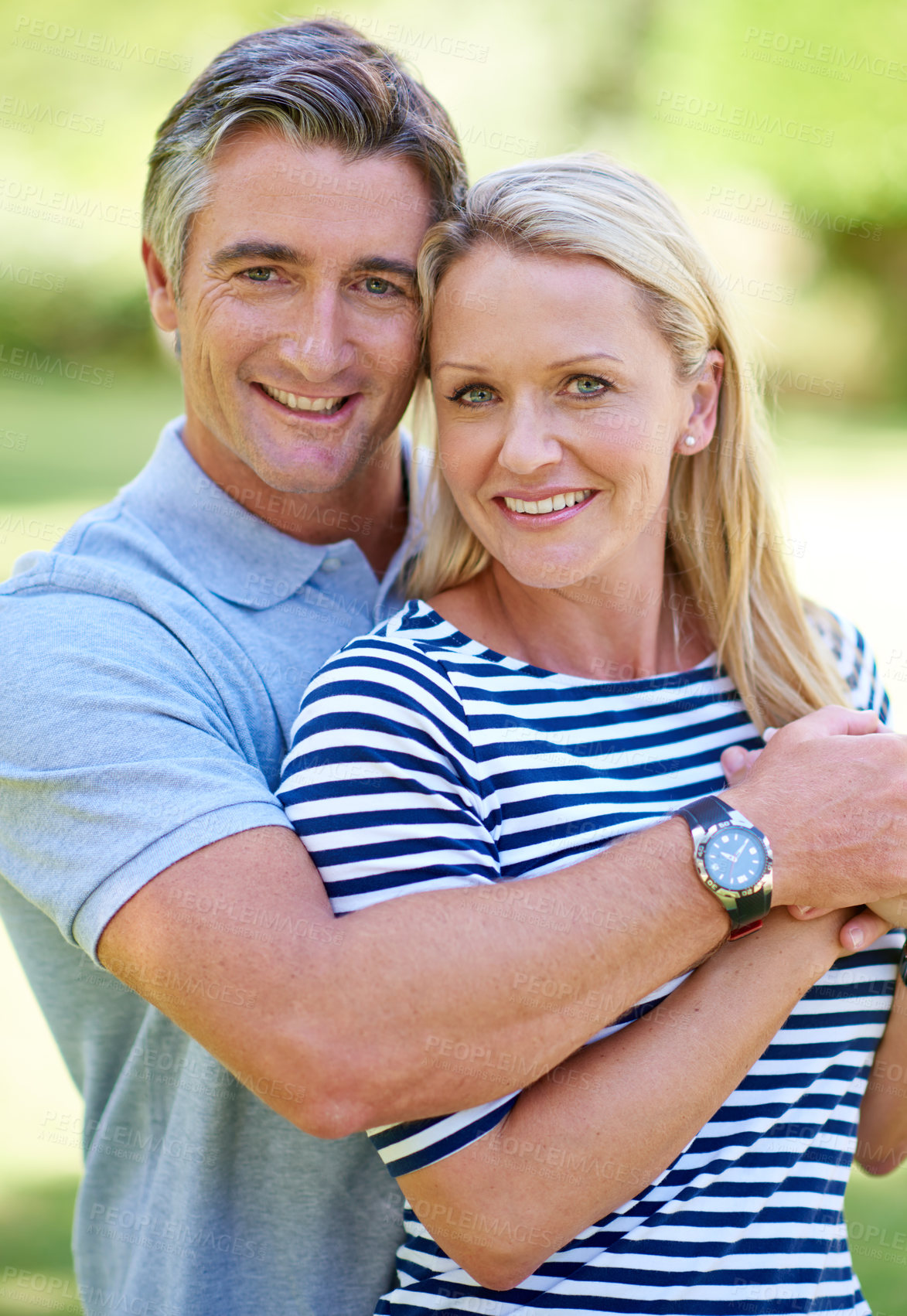 Buy stock photo Cropped shot of an affectionate mature couple enjoying a day in the park