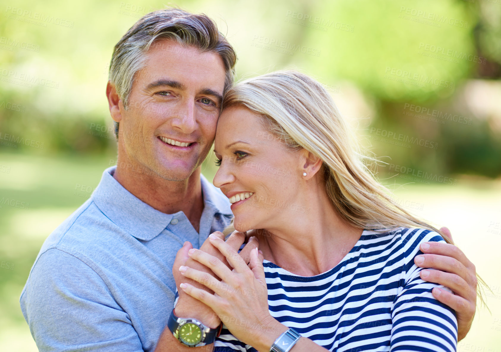 Buy stock photo Cropped shot of an affectionate mature couple enjoying a day in the park