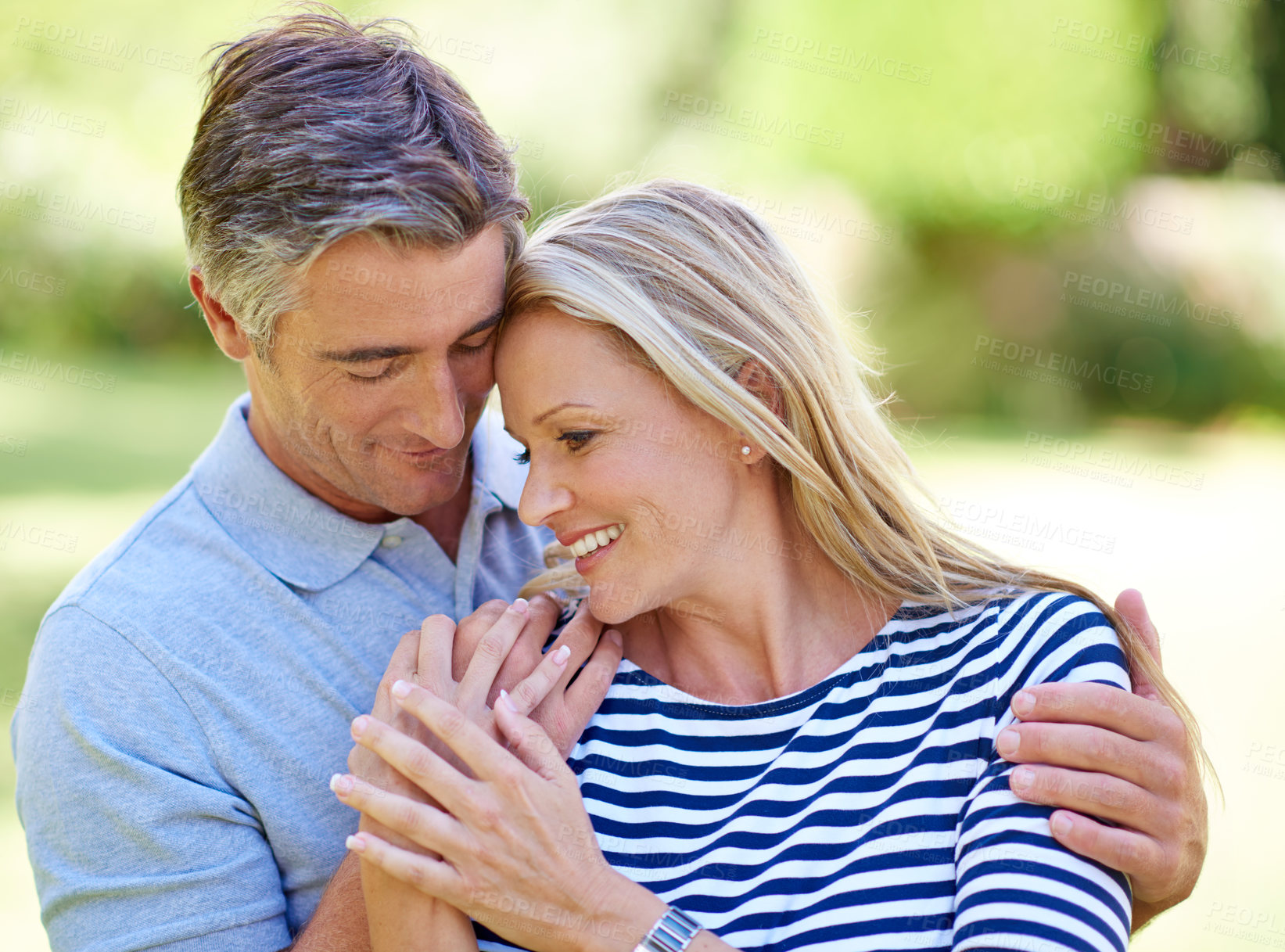 Buy stock photo Cropped shot of an affectionate mature couple enjoying a day in the park