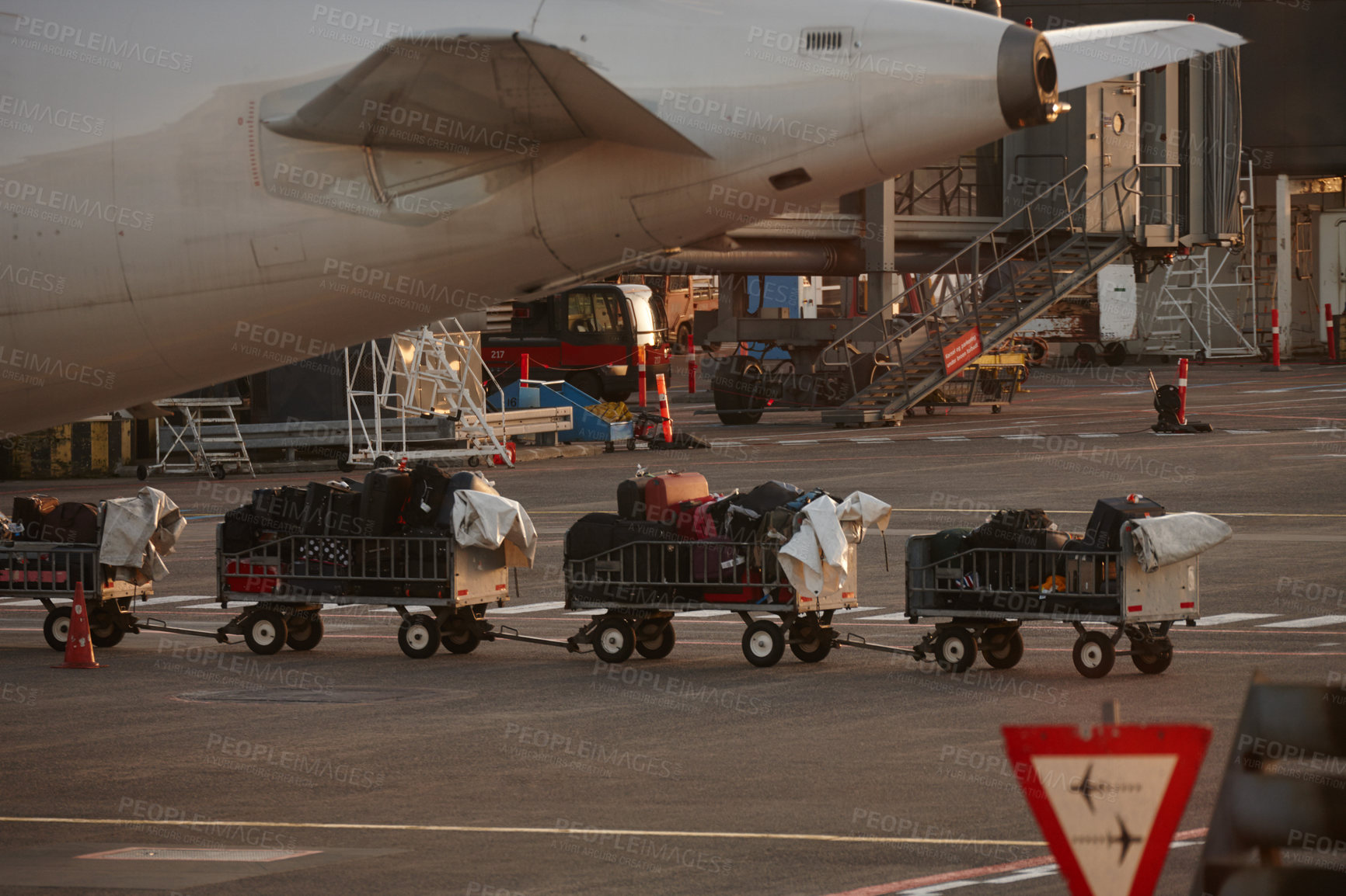 Buy stock photo Shot of luggage being taken to the plane