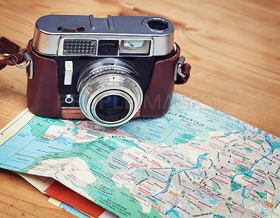 Buy stock photo Holiday, map and photography with camera on table for itinerary schedule, adventure explore and direction. Travel, vintage and trip with vacation planning for tourism, navigation and discovery