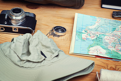 Buy stock photo Vacation, map and compass with camera on table for itinerary schedule, adventure explore and direction. Vintage, photography and travel with holiday planning for tourism, navigation and discovery