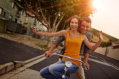 Buy stock photo Shot of a happy young couple enjoying a bicycle ride together