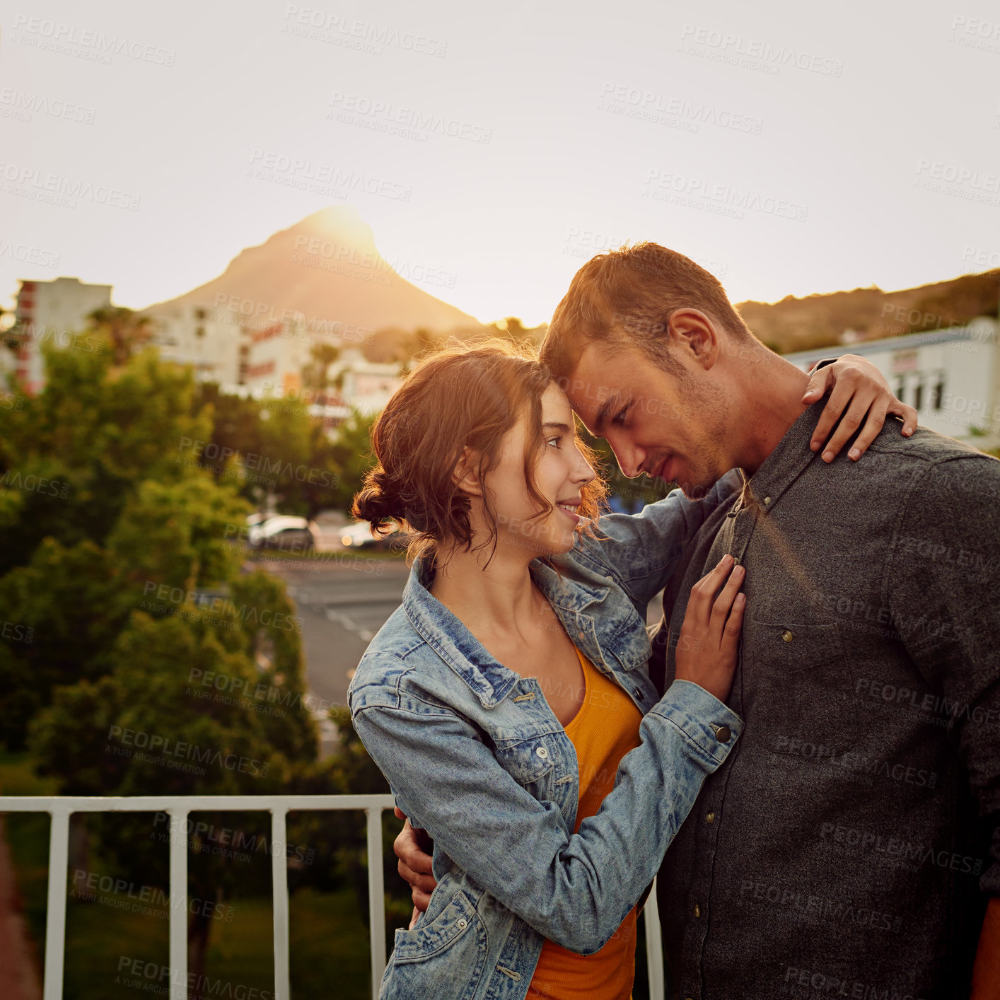 Buy stock photo Shot of a happy young couple enjoying a romantic moment in the city