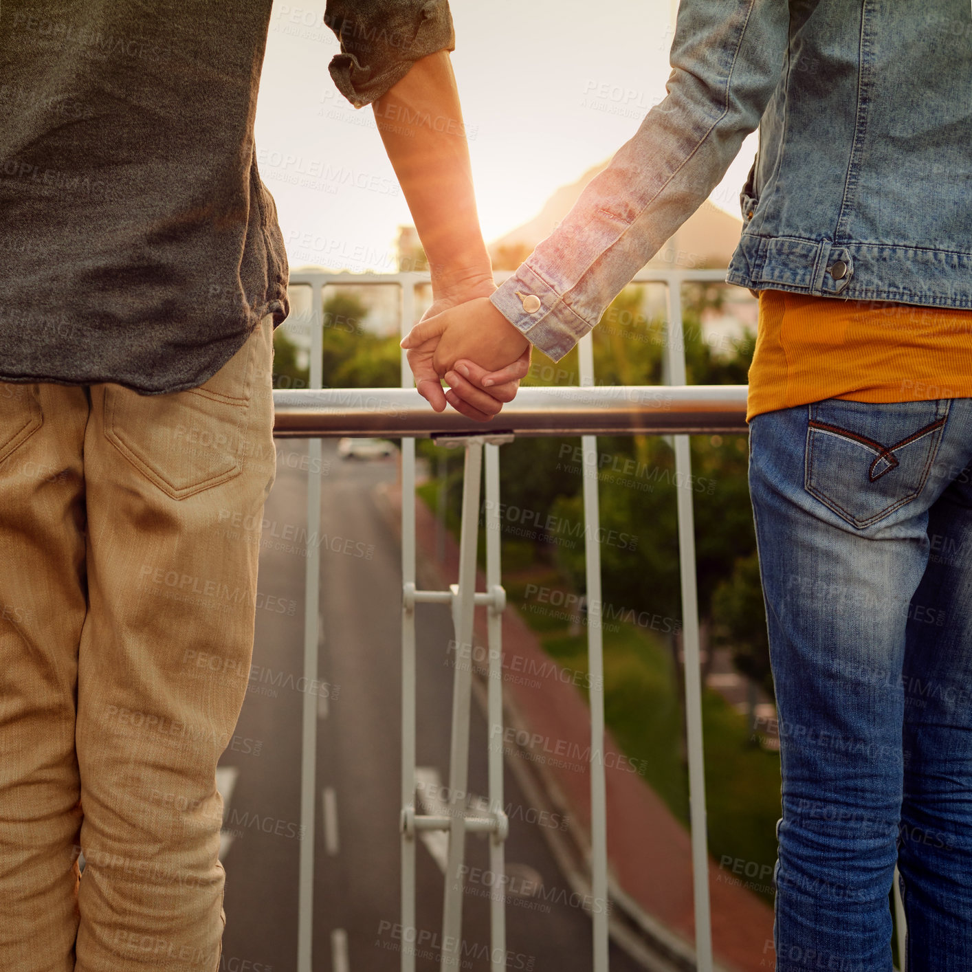 Buy stock photo Rearview shot of a couple standing together on a city bridge and looking at the view