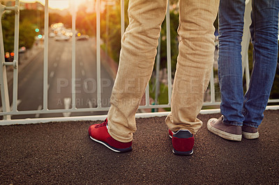 Buy stock photo Rearview shot of a couple standing together on a city bridge