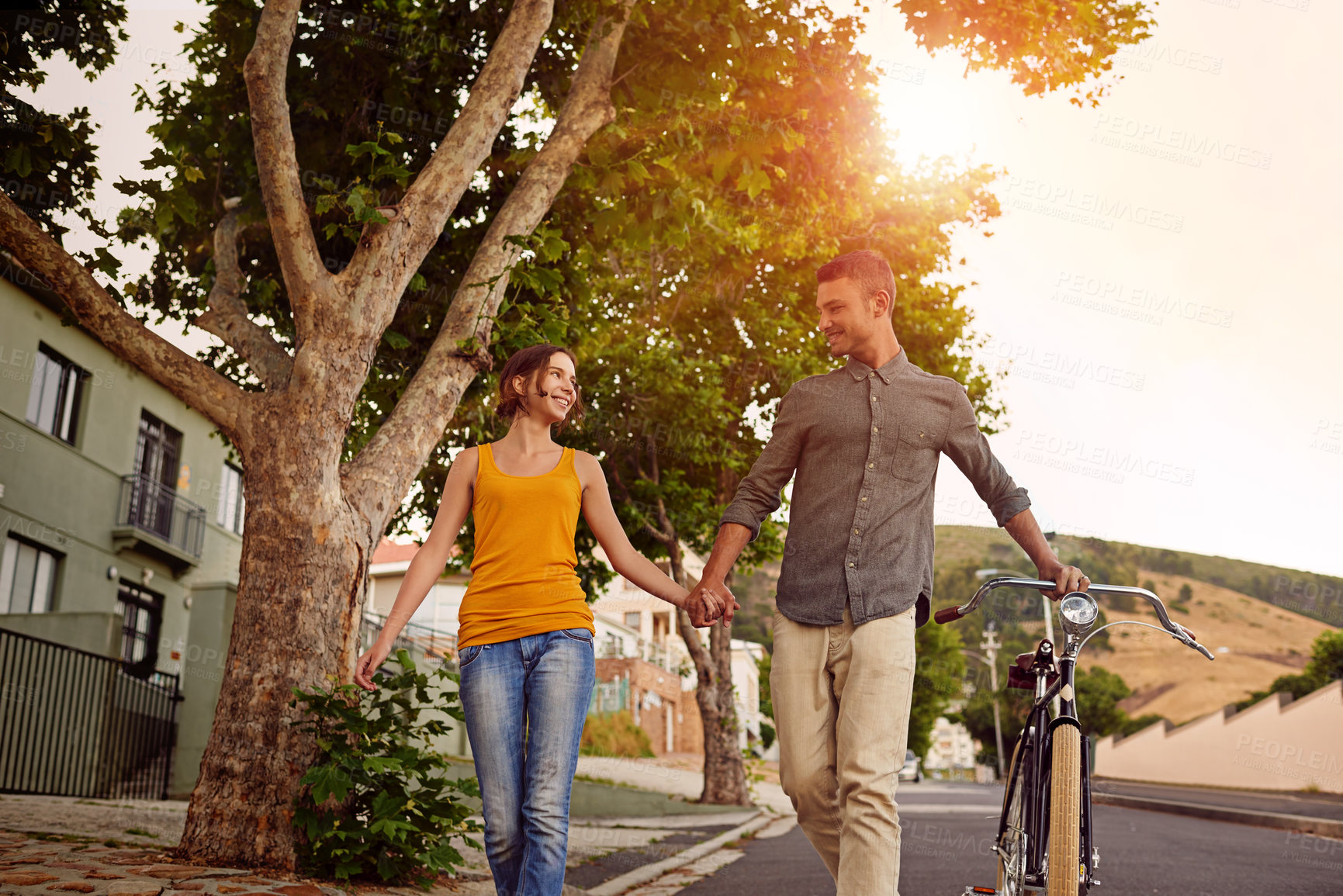 Buy stock photo Shot of a happy young couple enjoying a romantic walk together outdoors