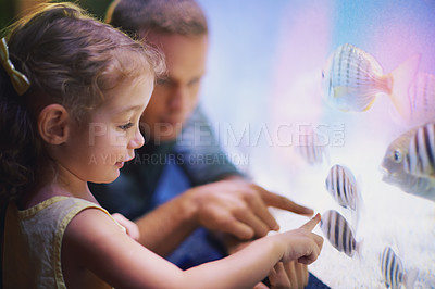 Buy stock photo Shot of a father taking his little daughter on an outing to the aquarium