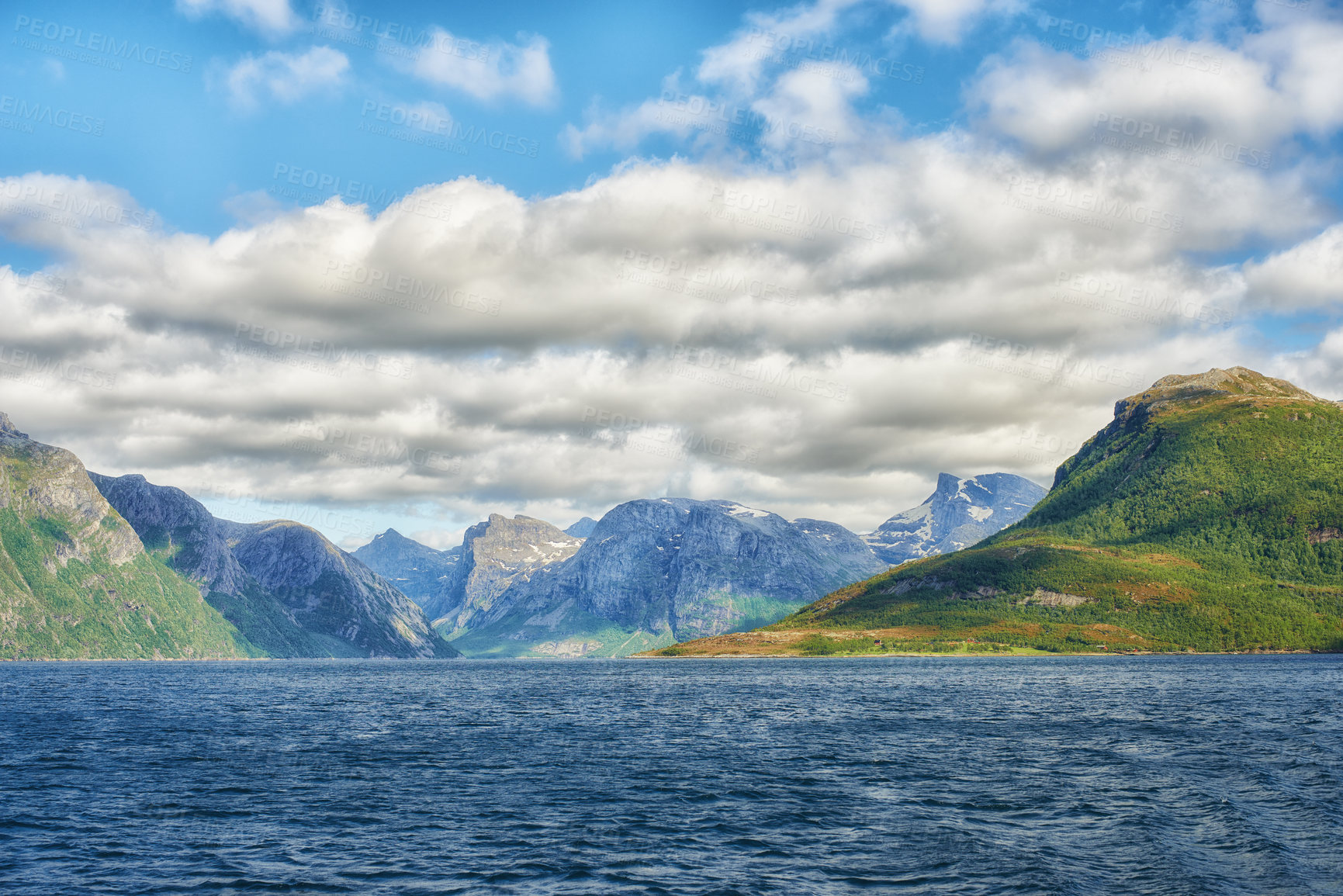 Buy stock photo Landscape of mountains north of polar and arctic circle in Bodo, Norway. Scenic view of green hills surrounded by ocean in remote area with clouds. Traveling abroad, overseas for holiday and vacation