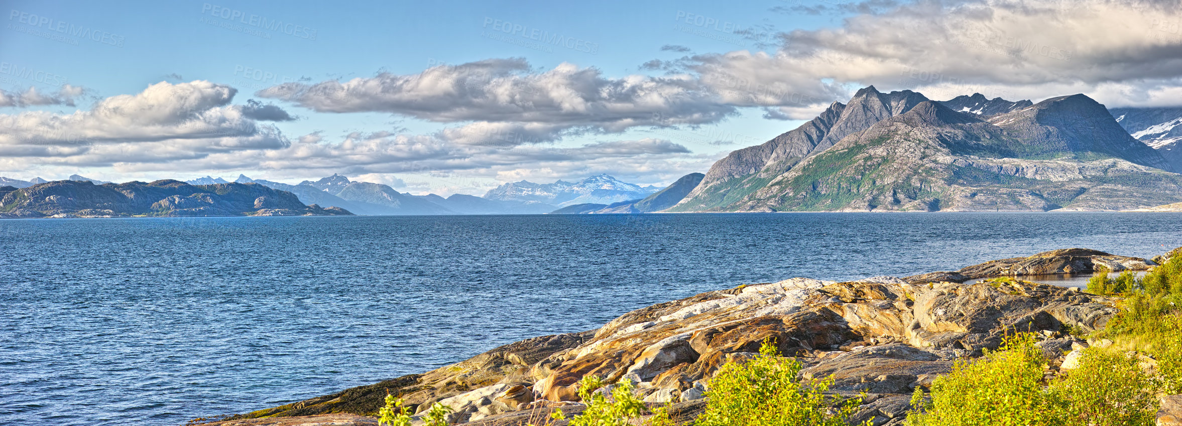 Buy stock photo Coast, mountain and ocean with view of nature in Norway for horizon, sustainability or travel. Clouds, earth and environment with natural terrain in Europe for conservation, holiday or vacation