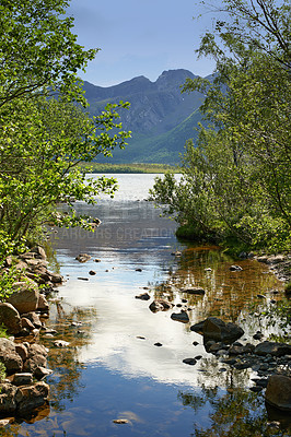 Buy stock photo Landscape of lake and river north of polar and arctic circle in Norland. Mountains and hills in remote area with rocky stream in Bodo, Norway. Traveling abroad and overseas for holiday and vacation