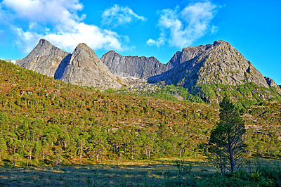 Buy stock photo Mountain, moss and clouds in blue sky in nature by journey for travel destination in Norway. Environment, landscape and peak for tourism vacation, holiday or trip to landmark in countryside scenery.