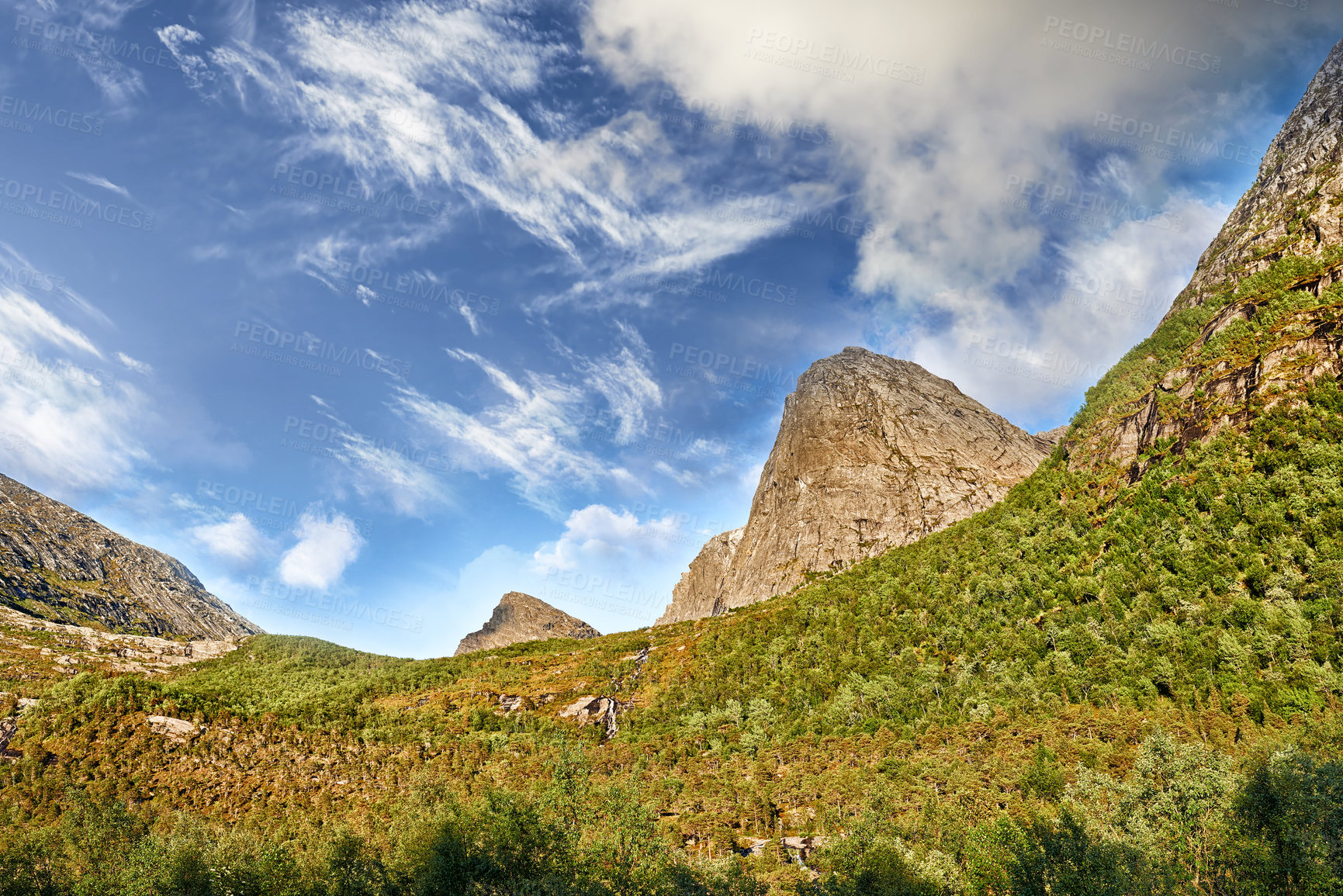 Buy stock photo Mountains, moss and clouds in blue sky in environment by journey for travel destination in Norway. Nature, landscape and peak for tourism vacation, holiday or trip to landmark in countryside scenery.