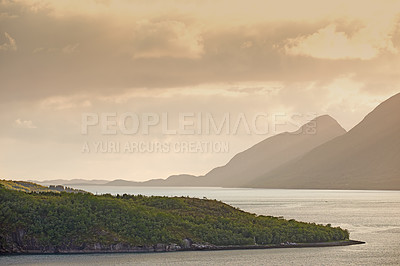 Buy stock photo Landscape, mountains and fjord with ocean, clouds and sky with sunset, ecosystem and mock up space by woods. Outdoor, sea and hill with forest, growth and coastal environment in summer in Norway