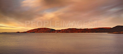 Buy stock photo Landscape of lagoon mountains and sunset clouds over calm and serene polar arctic lake in Norway. Scenic view of barren hills in remote area. Traveling abroad and overseas for holiday and vacation