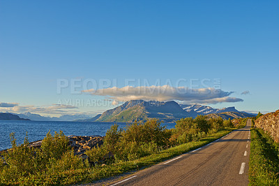 Buy stock photo Fjord, road and sky with clouds by mountains, nature and trees for transport system in summer. Landscape, mockup and space with highway, infrastructure and travel in environment by street in Norway