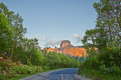 Buy stock photo Mountain pass, road and travel with view of nature location for remote holiday or vacation. Forest, Norway and trees with asphalt route in environment for journey or trip to wilderness destination