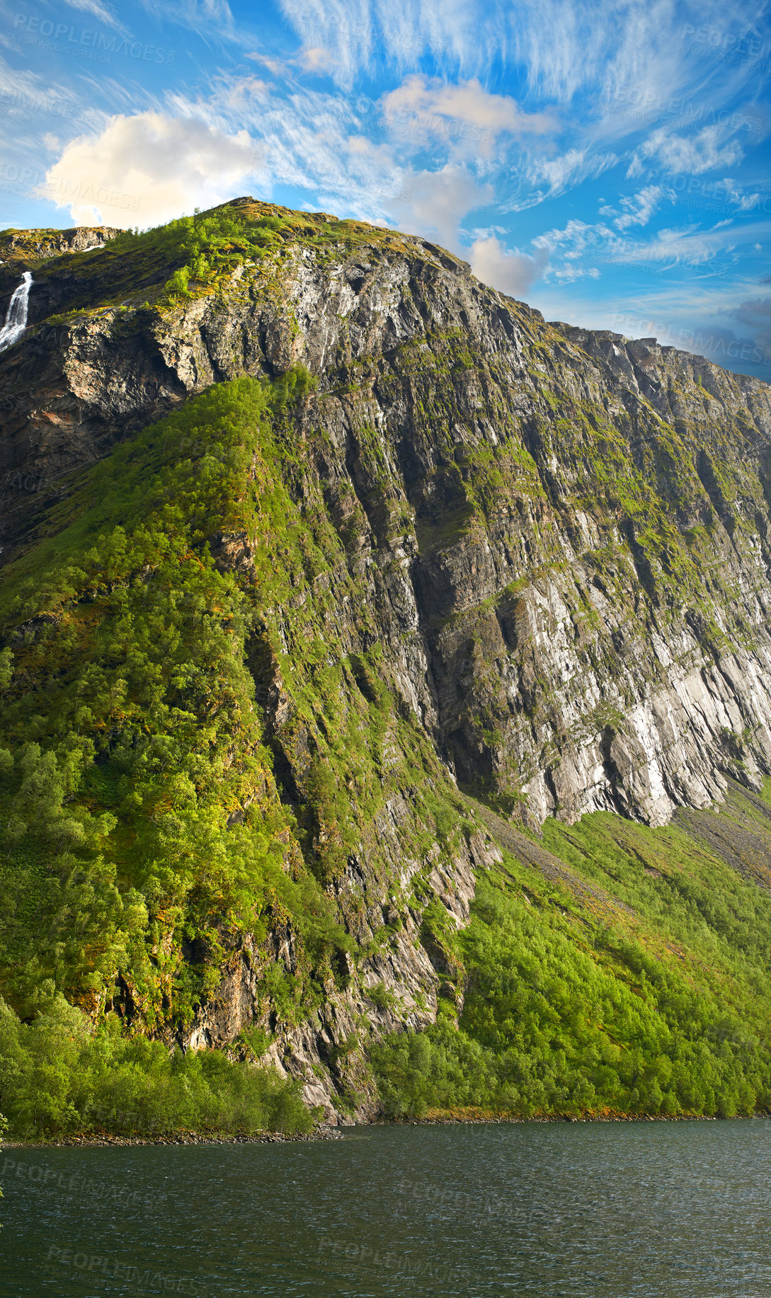 Buy stock photo Moss, nature and lake with mountain, clouds or environment for travel in Switzerland. Trees, river and landscape for tourism adventure, hiking or rock climbing in countryside outdoor for background