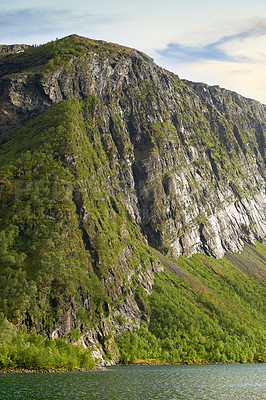 Buy stock photo The picturesque coast of the mountain lake of Norway,
close to the city of Bodo. Hiking trail up the beautiful mountain in Nordland against a cloudy blue sky. Enjoy the view from the peak