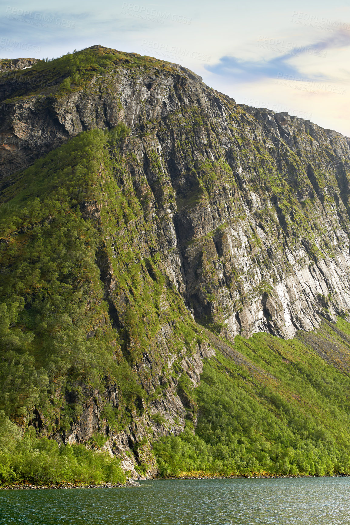 Buy stock photo The picturesque coast of the mountain lake of Norway,
close to the city of Bodo. Hiking trail up the beautiful mountain in Nordland against a cloudy blue sky. Enjoy the view from the peak