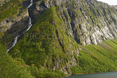 Buy stock photo Forest, nature and river with mountain or green environment for travel in Norway. Trees, lake and moss on landscape for tourism adventure, hiking or rock climbing in countryside outdoor on background