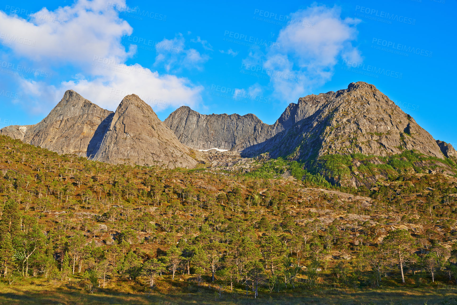 Buy stock photo Mountain, greenery and clouds in blue sky in nature by journey for travel destination in Norway. Environment, landscape and peak for vacation, holiday or trip to landmark in countryside scenery.