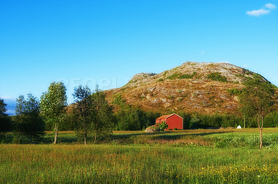 Buy stock photo Field, countryside and outdoor travel for peace, norway and mountain environment for nature. Barn, ecology and green location for earth vacation or holiday, rural building and sustainable aesthetic