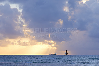 Buy stock photo Clouds, sunset and nature with boat in ocean for environment, travel or tourism destination. Earth, peace and yacht in calm blue water with waves for holiday, vacation or tropical island in Hawaii