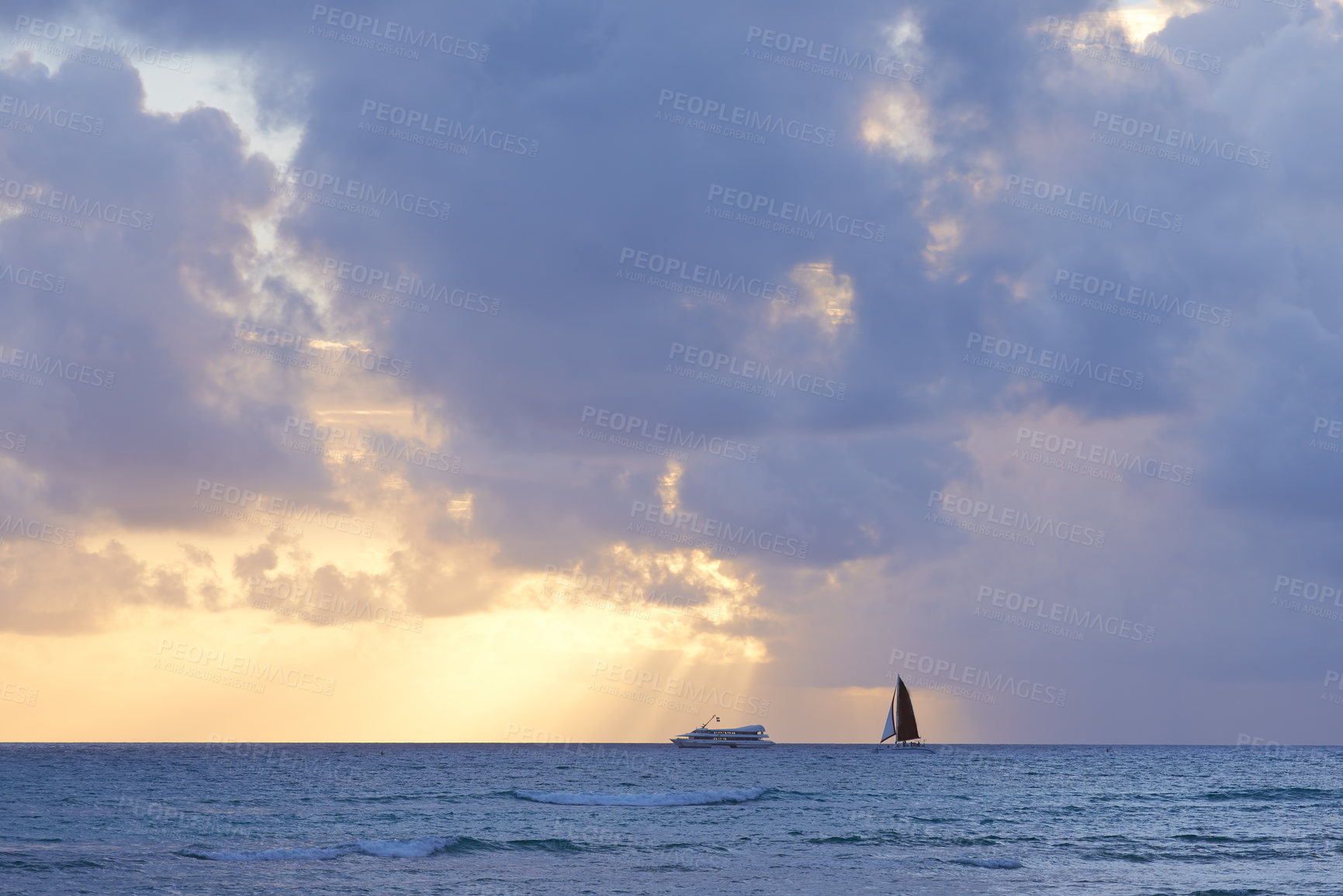 Buy stock photo Clouds, sunset and nature with boat in ocean for environment, travel or tourism destination. Earth, peace and yacht in calm blue water with waves for holiday, vacation or tropical island in Hawaii