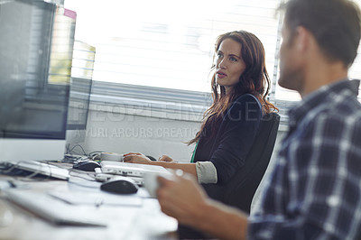 Buy stock photo Cropped shot of two coworkers sitting in the office