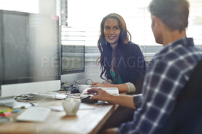 Buy stock photo Cropped shot of two coworkers sitting in the office