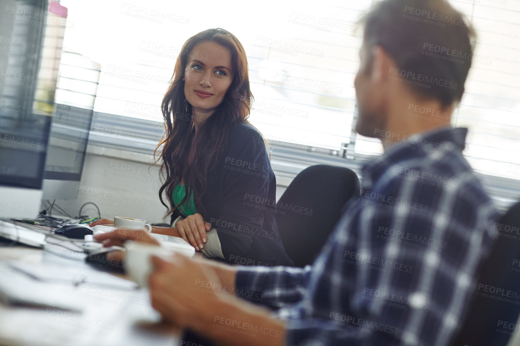 Buy stock photo Cropped shot of two coworkers sitting in the office