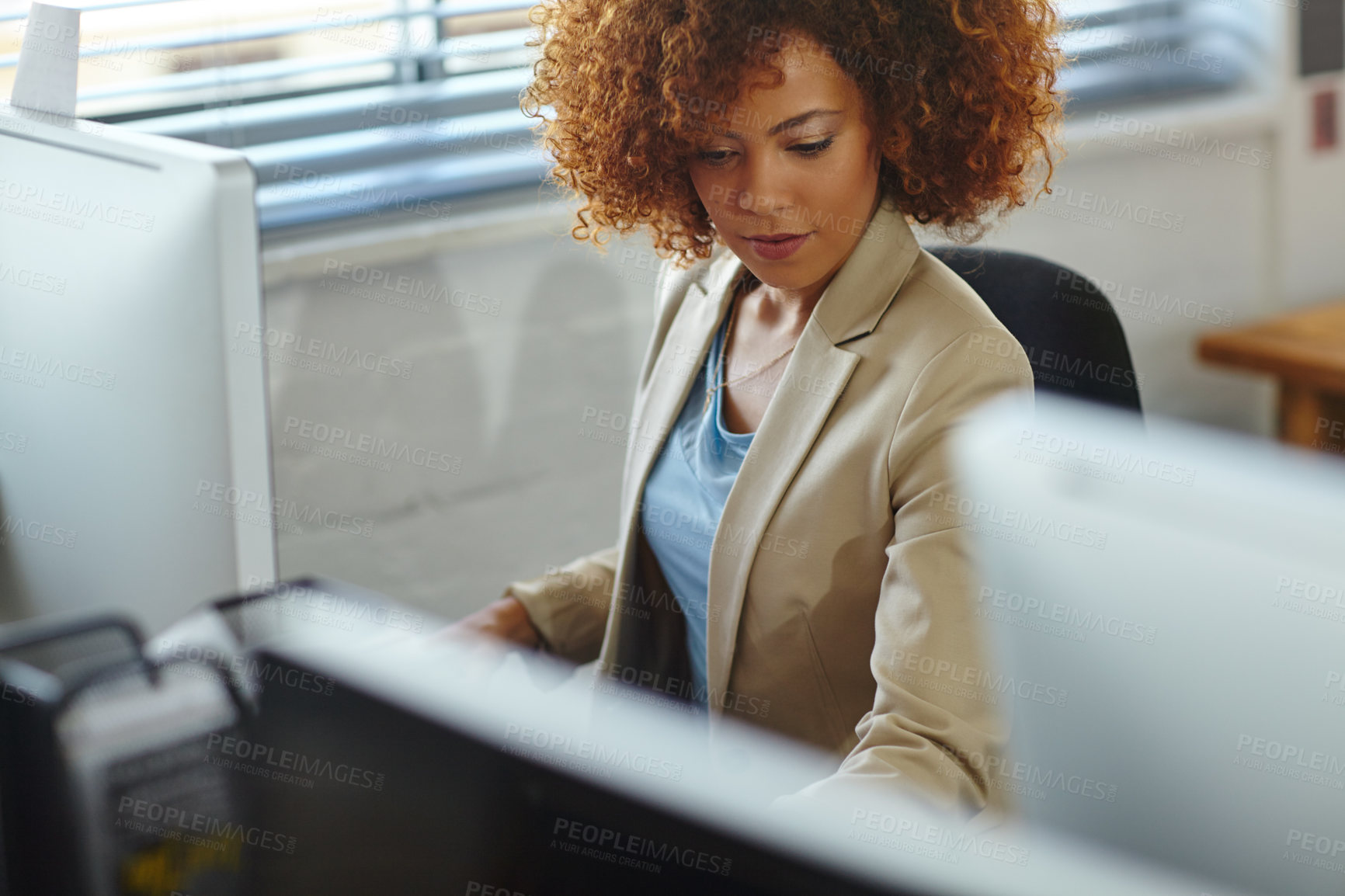 Buy stock photo Cropped shot of a beautiful young businesswoman sitting in her office