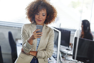Buy stock photo Cropped shot of a beautiful young businesswoman using her phone in the office