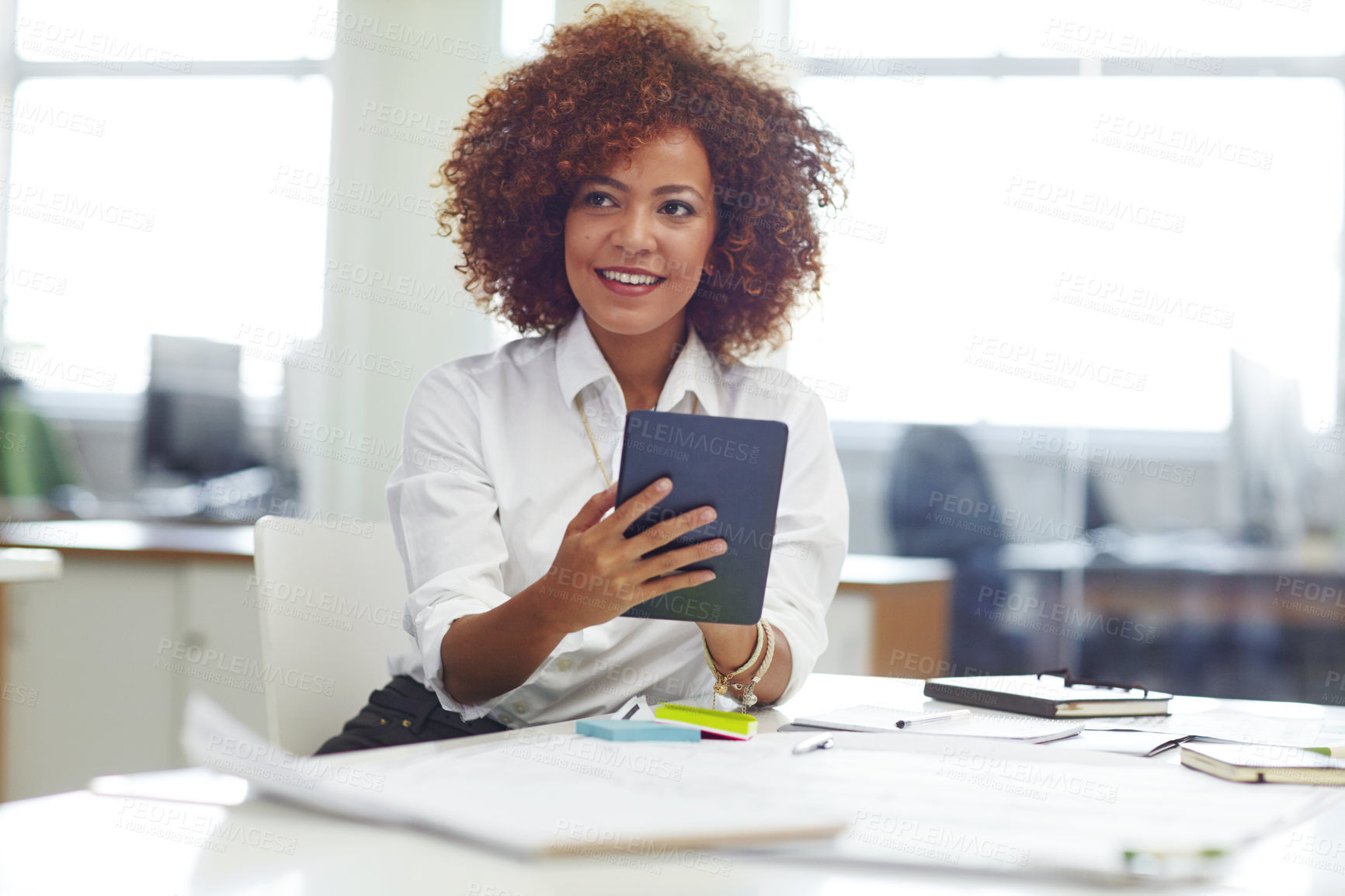 Buy stock photo Cropped shot of a beautiful young businesswoman using her tablet in the office