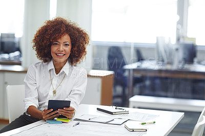 Buy stock photo Cropped shot of a beautiful young businesswoman using her tablet in the office