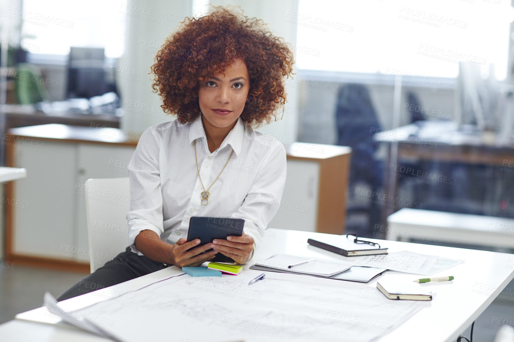 Buy stock photo Cropped shot of a beautiful young businesswoman using her tablet in the office