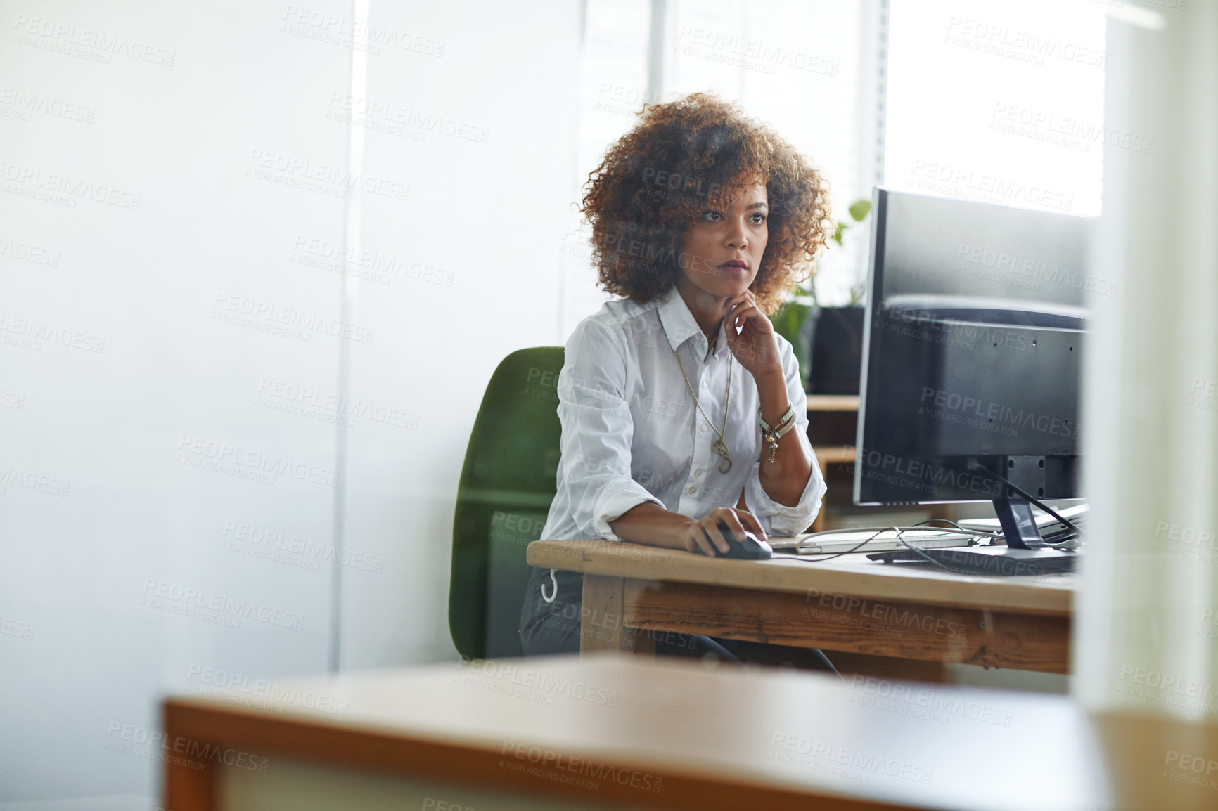 Buy stock photo Cropped shot of a beautiful young businesswoman sitting in her office